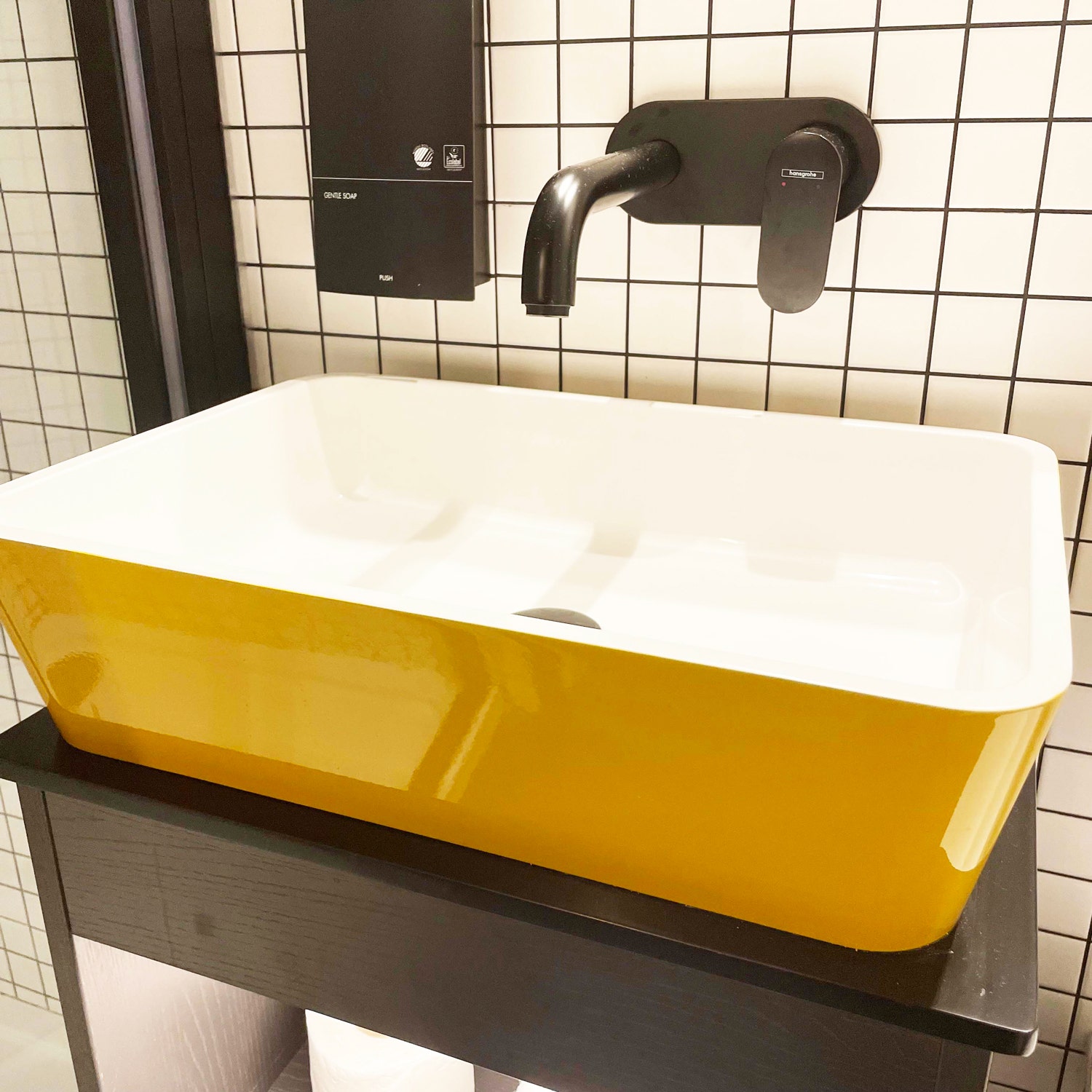 The Snug Townhouse yellow wash basin and black tap