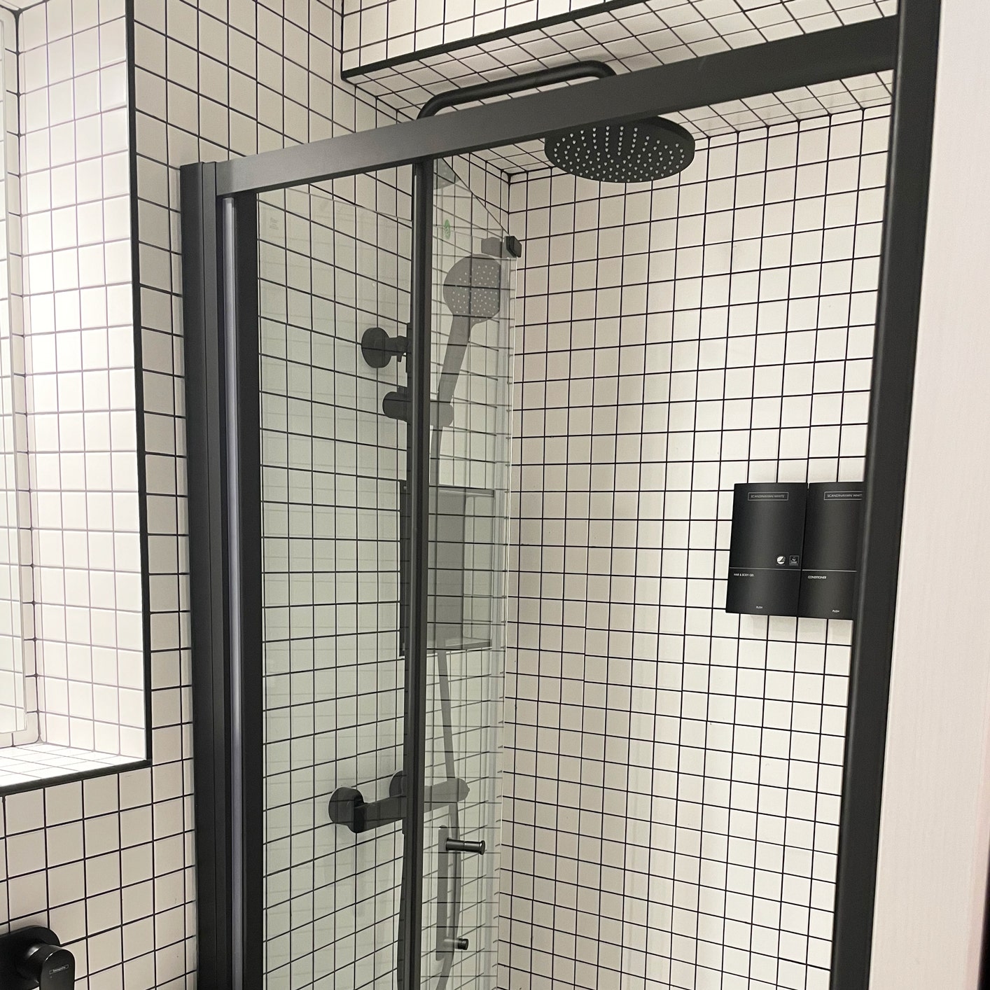 The Snug Townhouse white wall tile, black shower enclosure and valve